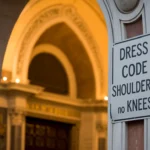 Church entrance in Rome showing dress code requirements for visitors