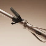 Corded curling iron wrapped neatly, highlighting its design and functionality