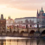Prague skyline at sunrise featuring the castle and Charles Bridge