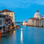 Scenic view of the Grand Canal in Venice at dusk, reflecting the city's charm