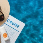 Cruise vacation essentials arranged on a vibrant ocean backdrop.
