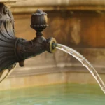 Close-up of a Nasoni fountain in Rome with flowing water